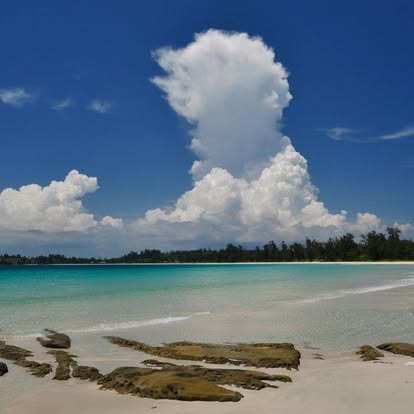 Beach and towering cloud at sunset