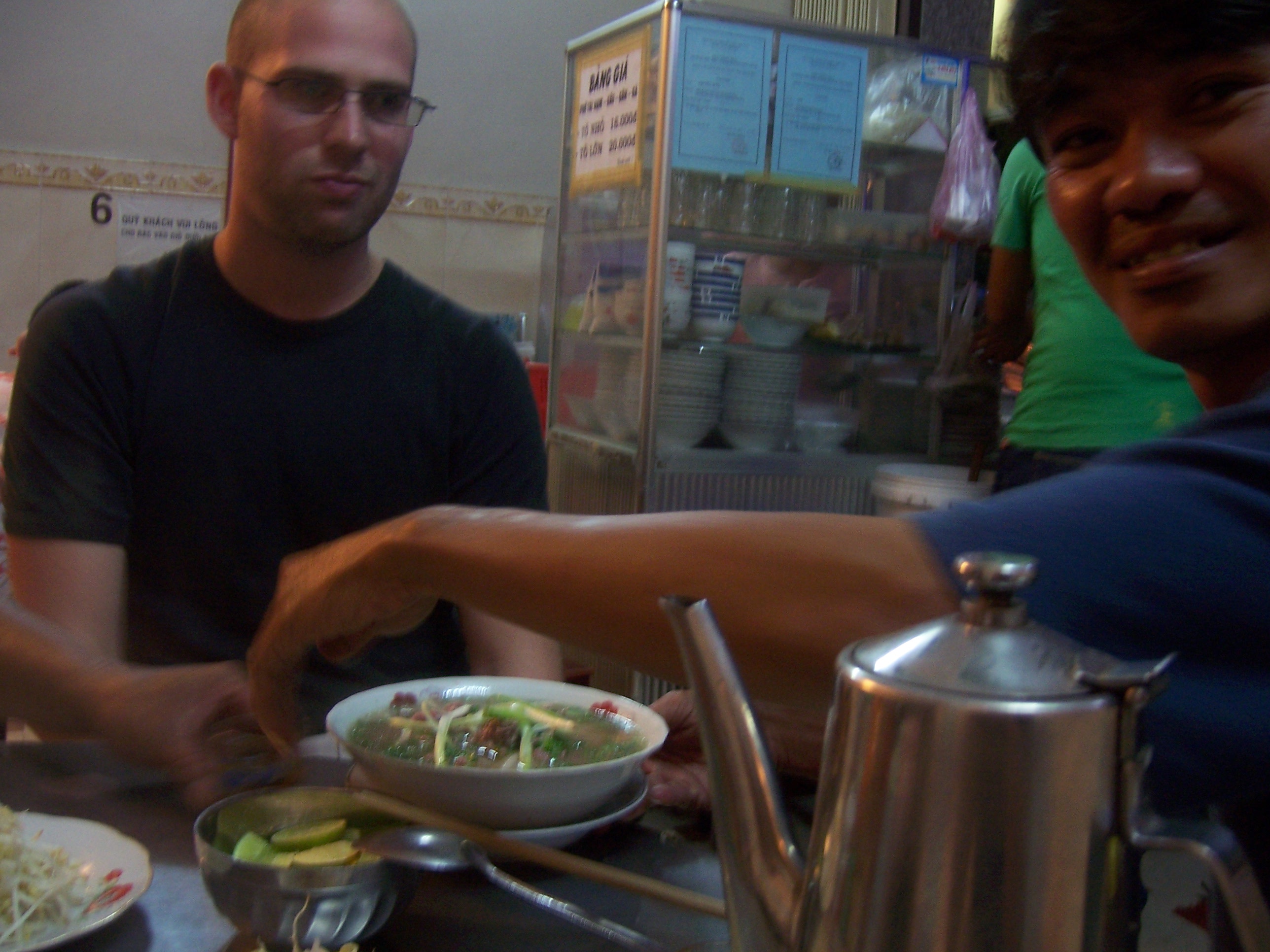 Pho table with herbs and lime being served