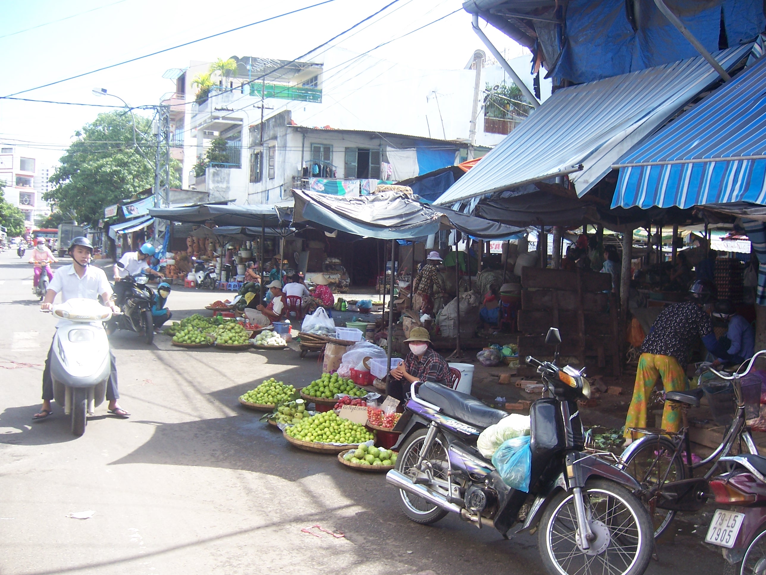 Busy market with scooters and produce