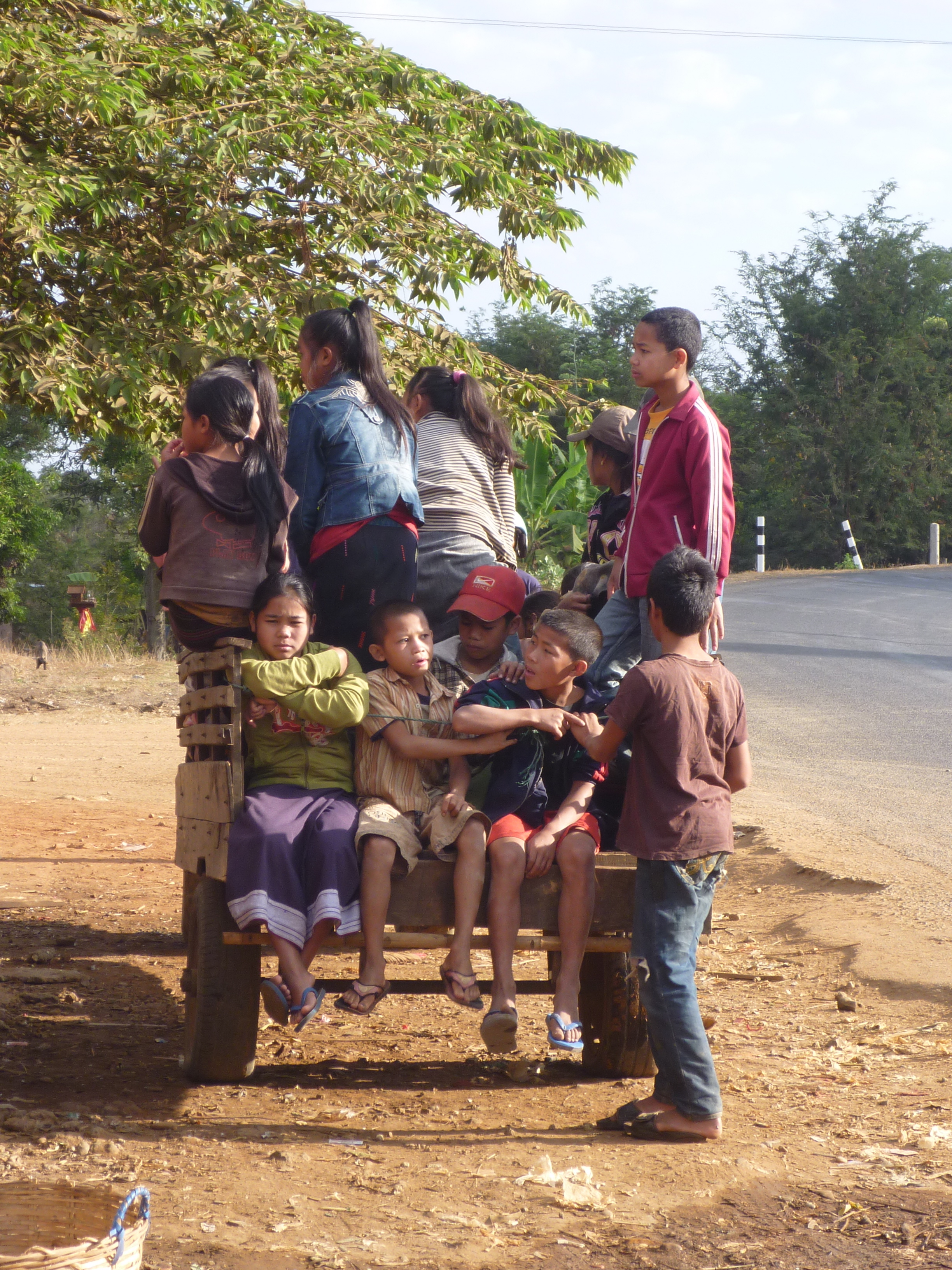 “Happiness doesn’t cost a thing.” Kids in a wooden cart